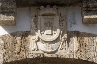 Tarifa, İspanya, Endülüs - 31 Mart 2025: Santa Maria Meydanı 'nda (Plaza de la Ranita) bulunan Ortaçağ Tarifa Eski Tahıl ambarı (Antiguo Posito de Tarifa) cephede silah ceketi)