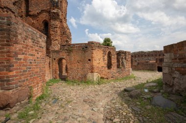Torun, Poland - June 26, 2020: Ruins of gothic Teutonic Order 13th century Torun Castle. It was stronghold surrounded by defensive wall made of red brick