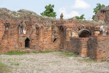 Torun, Poland - June 26, 2020: Ruins of gothic Teutonic Order 13th century Torun Castle. It was stronghold surrounded by defensive wall made of red brick