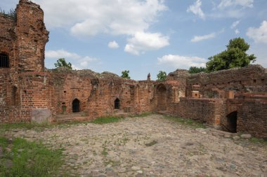 Torun, Poland - June 26, 2020: Ruins of gothic Teutonic Order 13th century Torun Castle. It was stronghold surrounded by defensive wall made of red brick