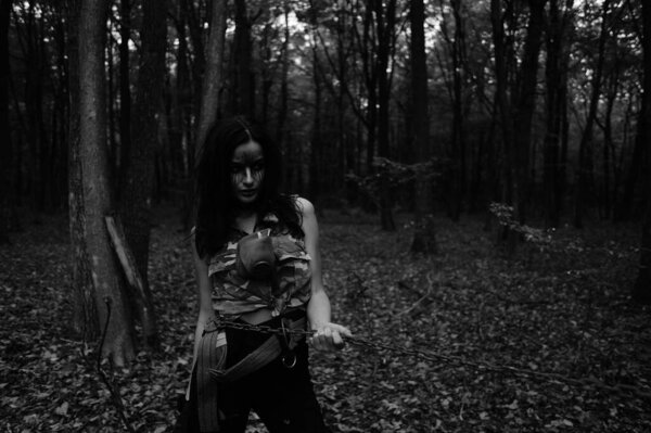 Black-white photo of a warrior girl in the forest