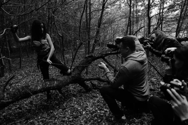 group of film crew people in the forest