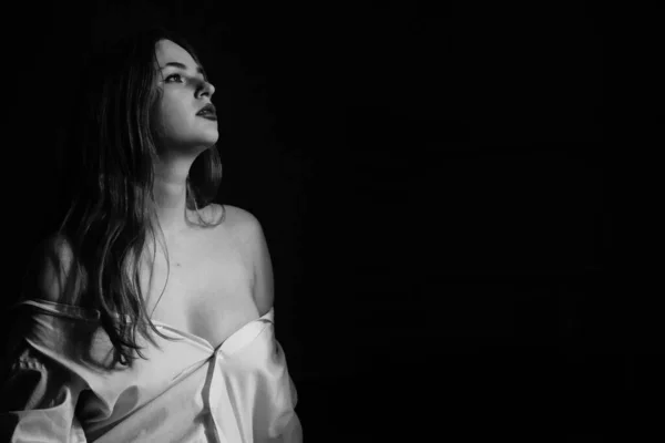 一个穿着一件白衬衫的年轻漂亮姑娘站在演播室里赤身裸体的黑白照片 — 图库照片