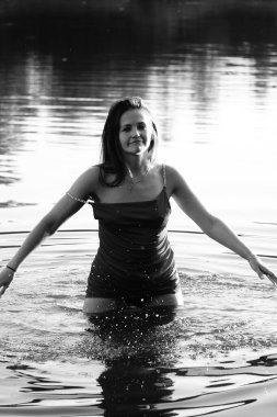 Parktaki gölde çekilmiş siyah beyaz bir kız fotoğrafı..   