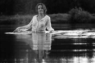 Parktaki gölde çekilmiş siyah beyaz bir kız fotoğrafı..   