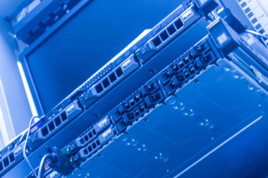 Bir veri merkezi içerisindeki modern sunucu raflarının yakın görüntüsü, dijital altyapı için gerekli teknoloji, donanım ve ağ bileşenlerini sergiliyor.