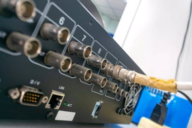 Bir ofis ortamında bağlantı ve kablo yakalayan elektronik ekipmanların ayrıntılı görüntüsü. Teknoloji ve donanım temaları için ideal.