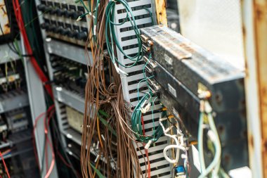 Elektrik kontrol panelinde birbirine dolanmış kablo ve kabloların yakın görüntüsü. Bu resim endüstriyel ortamlardaki bağlantıların ve teknolojinin karmaşıklığını vurgular.