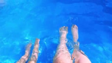 Yüzme havuzunda kadın ve çocuk ayakları