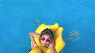 Lastik ördekli şirin küçük kız havuzda eğleniyor.