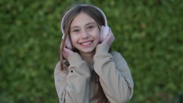 Smiling Child Listening Music Outdoors Smiling Little Girl Headphones Has — Stock Video
