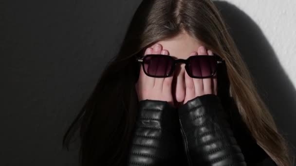Girl Leather Jacket Sunglasses Covers Her Face Her Hands Upset — Vídeo de stock