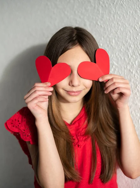 Slow motion video of a cute teenager holding paper hearts, st.Valentines day concept