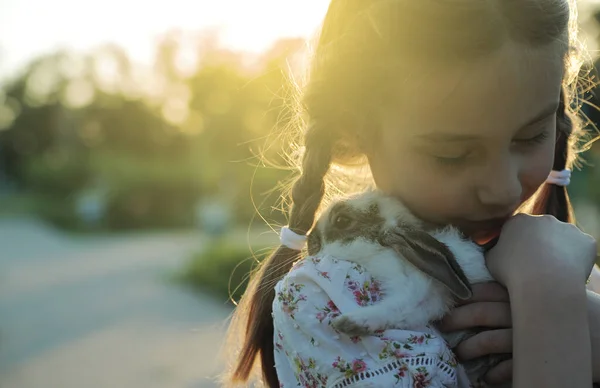 Girl Hugging Baby Rabbit Outdoors — Stock Photo, Image