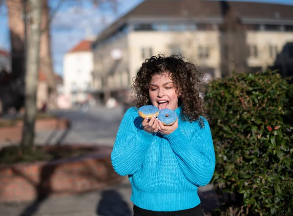 Grappige Jonge Vrouw Met Krullend Haar Vasthouden Donuts Outdoor — Stockfoto