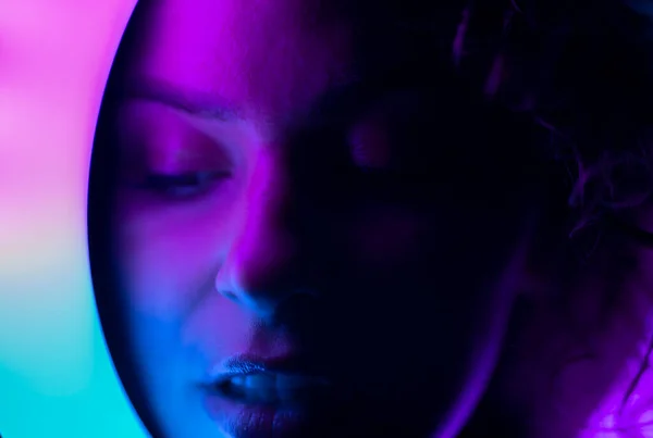 Blurred portrait of woman in neon light