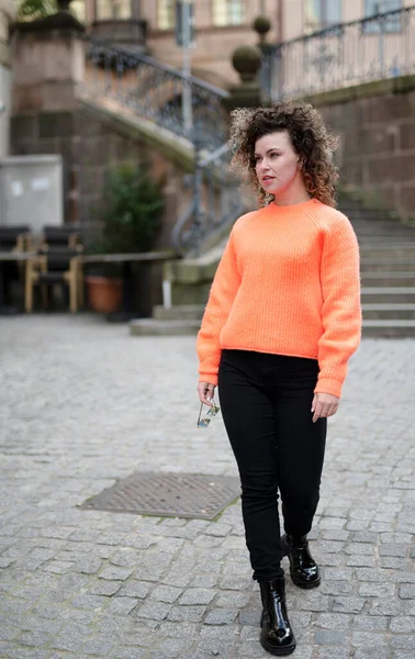 Fashionable Young Woman Curly Hair Orange Sweater Dark Sunglasses Walking — Stock Photo, Image