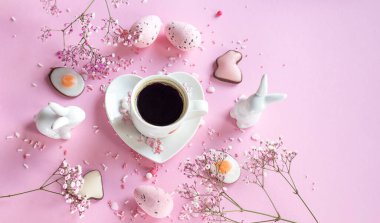 Fragrant coffee. coffee for easter on a pink background, bunnies and flowers. Easter eggs. coffee. copy space.