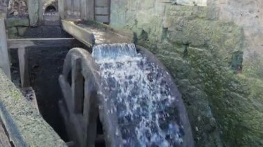 Water Mill. The water mill is spinning and water is pouring. Medium plan