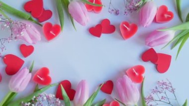 St. Valentine's Day. Frame from pink tulips and red hearts on a white background. copy space