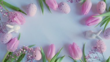 Easter. Frame from pink tulips and eggs on a white background. copy space