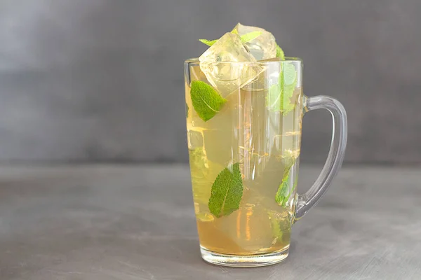 Cooling drink with ice and mint. Glass of cold drink