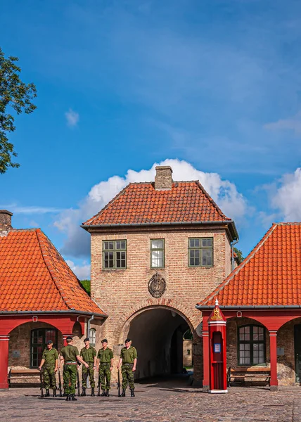 stock image Copenhagen, Denmark - September 13, 2010: Closeup of kastellet, citadel, North gate entrance and tower while seeing line of soldiers in front. Red roofs and blue cloudscapei