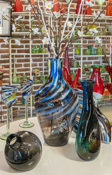 Meksika, Cabo San Lucas - 16 Temmuz 2023 La Fabrica de Vidrio Soplado. El yapımı cam fabrikası. Renkli vazolar ve içki bardakları sergileniyor.