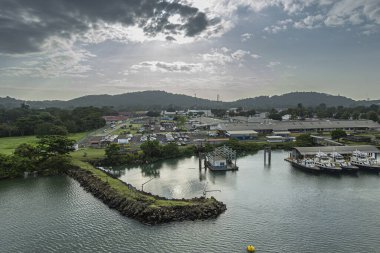 Panama Kanalı, Panama - 24 Temmuz 2023: Corozal Oeste Landing 'in kuzey rıhtımı, ulusal kasırga ve hava tahmini merkezi, mavi bulutlar altındaki küçük tekneleri koruyor.