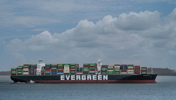 Panama Canal, Panama - July 24, 2023: Closeup, Evergreen container ship on Gatun Lake under blue cloudscape