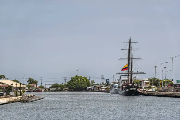 stock image Cartagena, Colombia - July 25, 2023: Tall sailing ship docked in historic old town port under blue sky. Other harbor shore  scenery