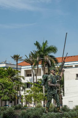 Cartagena, Colombia - July 25, 2023: Fighting man statue in front of Naval Base ARC Bolivar. The man is pictured as real life, yelling and shooting his rifle holding a flag post without the flag clipart