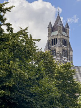 Brugge, Flanders, Belgium - June 22, 2024: Tower of Saint Salvator Cathedral seen from Saint Jan Hospital garden clipart