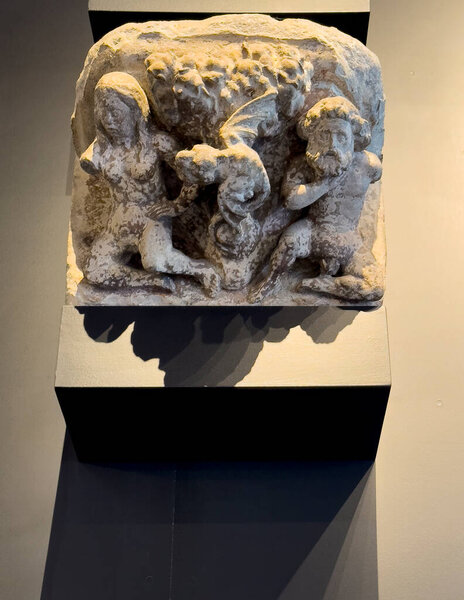 Brugge, Flanders, Belgium - June 25, 2024: Historic City Hall. Display of ancient art piece, Adam and Eve with winged devil in between