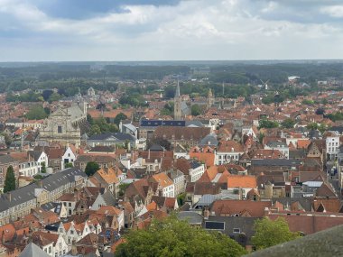 Brugge, Flanders, Belgium - June 22, 2024: From Halletoren: 4 churches, St. Walburge, St, Anna, English Convent, Jeruzalem chuch. Historic windmills along circle canal clipart