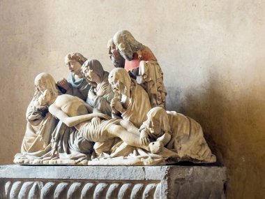 Trieste, Italy - June 27, 2024: Trieste, Italy - June 27, 2024: Cattedrale di San Giusto Martire, Cathedral at San Giusto castle. Pieta statue composition with seven persons around Jesus clipart