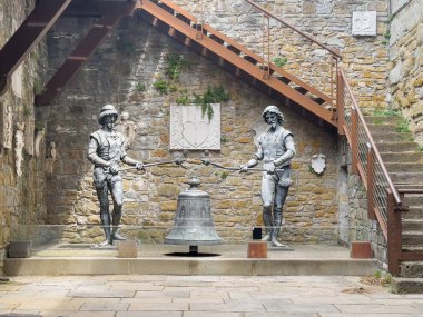 Trieste, Italy - June 27, 2024: Historic San Giusto castle. Bronze statues of bell ringers, Michez and Jachez, automatons that used to stand on the top front side of City Hall clock tower. Now replaced by the same clipart