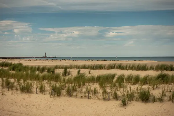 Dunkirk, France - September 16, 2018: Operation Dynamo beach from which the allied forces escaped away from the Germans during The Miracle of Dunkirk in 1940. Wide sandy landscape under light blue cloudscape