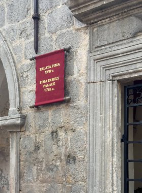 Kotor, Montenegro - July 2, 2024: Old historic downtown. Pima family mansion sign on facade closeup clipart