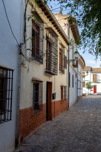 Granada, Spain - October 28, 2022: Narrow street in Granada, Spain on October 28, 2022