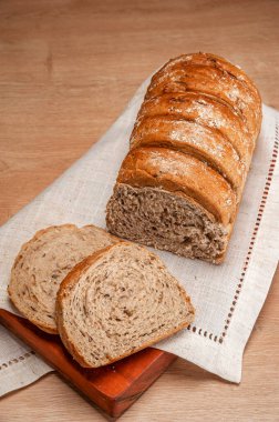 Wholemeal bread on wooden table.