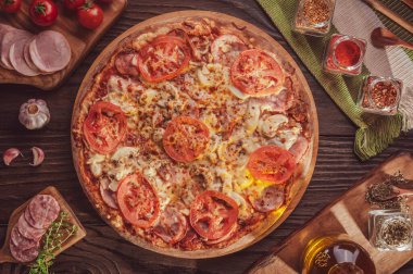 Brazilian pizza with mozzarella, tomato sauce, calabrese sausage, pork loin, mushroom, tomato, parmesan and oregano (Pizza especial) Top view.