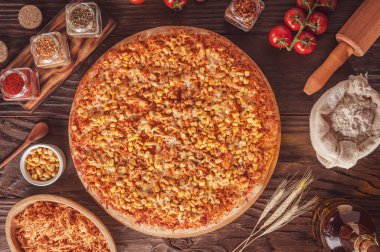 Brazilian pizza with mozzarella, chicken, corn and oregano. (Pizza de frango com milho) - Top view.