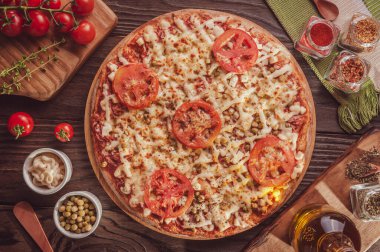 Brazilian pizza with mozzarella cheese, ham, tomato, hearts of palm, pea and catupiry (Pizza especial) - Top view.
