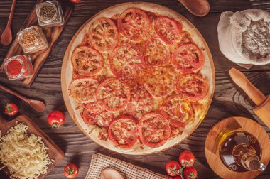Brazilian pizza with mozzarella, tomato and oregano (Pizza de mussarela) - Top view.