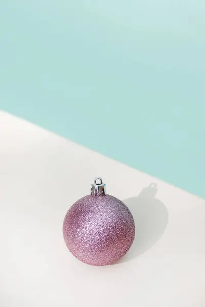 Pink Glitter Christmas Decoration Ball Blue Background Beige Table Shadow — Stock Photo, Image
