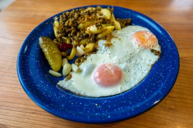 Healthy and delicious homemade dinner in a plate. Fried eggs, vegetables and pulses dal.