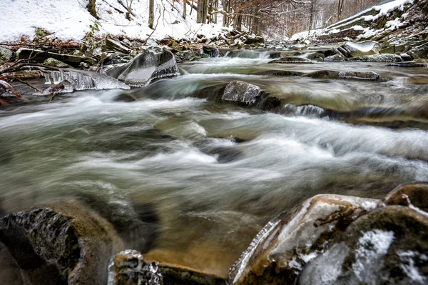 Mountain stream in winter scenery. Prowcza Stream, Bieszczady National Park, Carpathians, Poland. One of the most popular travel destinations in Poland.
