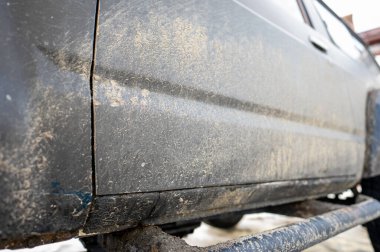 Splash and texture of mud on a car. Dirty car side.