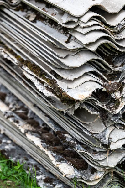 stock image A pile of asbestos removed from an old roof. Hazardous waste prepared for disposal.